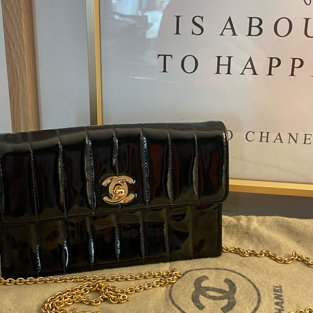 Classic Chanel Quilted Patent Leather Handbag with gold closure and chain strap